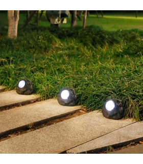 Tradineur - Pack de 3 lámparas solares con forma de piedra, foco, luz LED decorativa, impermeable, ecológica, jardín, patio, exterior (Gris - 11,5 x 9 x 9 cm)